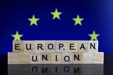 European Union Flag and words EUROPEAN UNION made of small wooden letters. Studio shot.