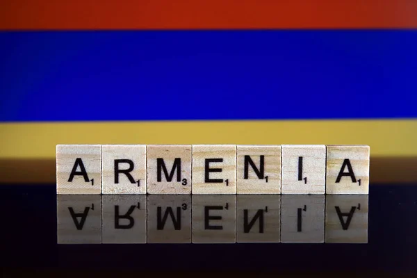 Armenia Flag and country name made of small wooden letters. Studio shot.