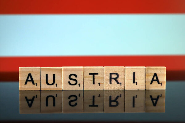 Austria Flag and country name made of small wooden letters. Studio shot.