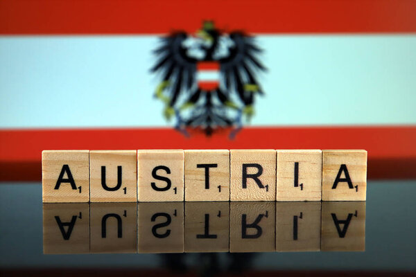 Austria Flag and country name made of small wooden letters. Studio shot.