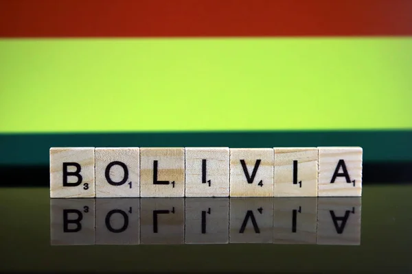 Bolivia Flag and country name made of small wooden letters. Studio shot.