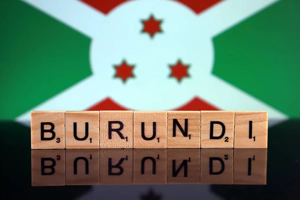 Burundi Flag and country name made of small wooden letters. Studio shot.