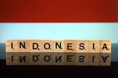 Indonesia Flag and country name made of small wooden letters. Studio shot.