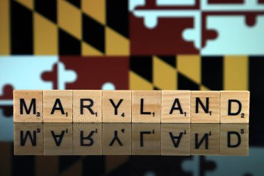 Maryland State Flag and state name made of small wooden letters. Studio shot.