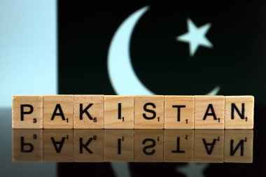 Pakistan Flag and country name made of small wooden letters. Studio shot.