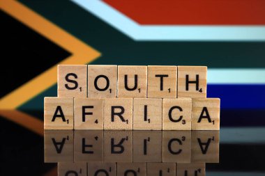 South Africa Flag and country name made of small wooden letters. Studio shot.