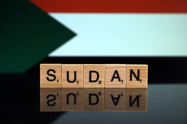 Sudan Flag and country name made of small wooden letters. Studio shot.
