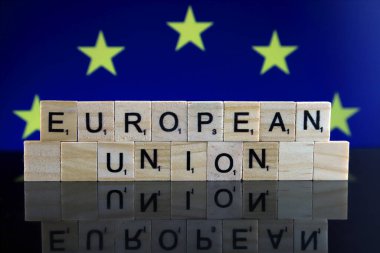 European Union Flag and words EUROPEAN UNION made of small wooden letters. Studio shot.