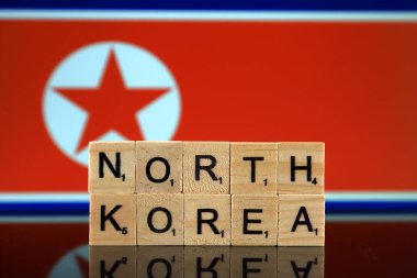 North Korea Flag and country name made of small wooden letters. Studio shot.