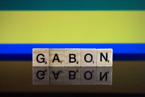Gabon Flag and country name made of small wooden letters. Studio shot.
