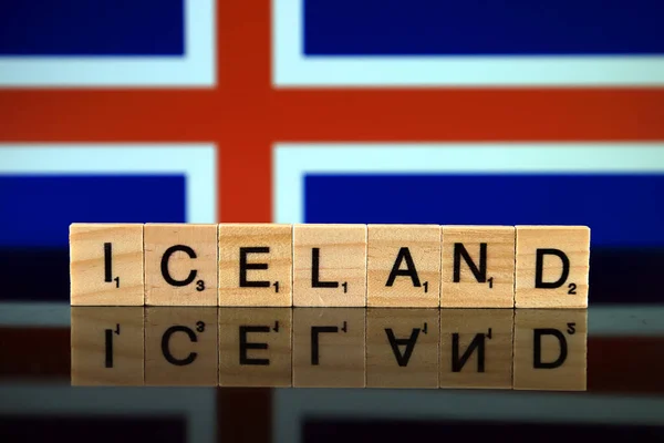 Iceland Flag and country name made of small wooden letters. Studio shot.