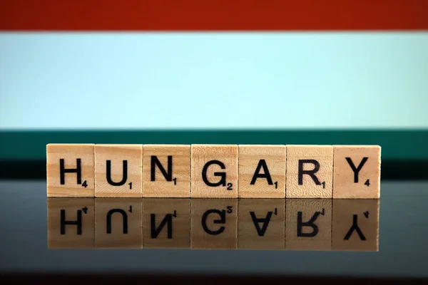 Hungary Flag and country name made of small wooden letters. Studio shot.