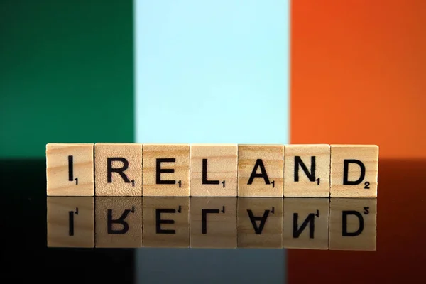Ireland Flag and country name made of small wooden letters. Studio shot.