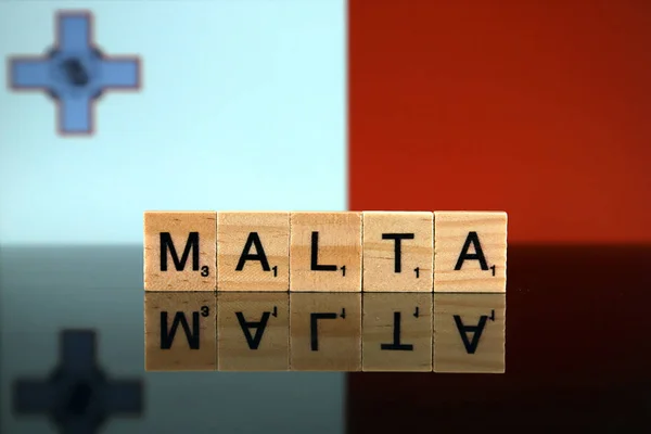 Malta Flag and country name made of small wooden letters. Studio shot.