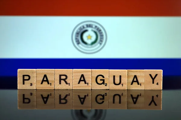 Paraguay Flag and country name made of small wooden letters. Studio shot.