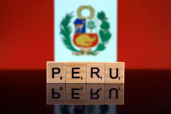 Peru Flag and country name made of small wooden letters. Studio shot.