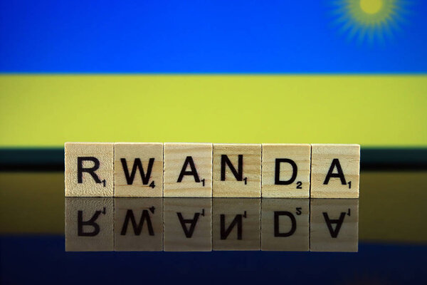 Rwanda Flag and country name made of small wooden letters. Studio shot.