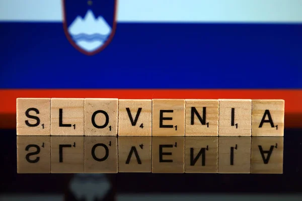 Slovenia Flag and country name made of small wooden letters. Studio shot.