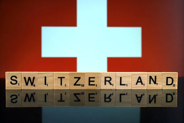 Switzerland Flag and country name made of small wooden letters. Studio shot.