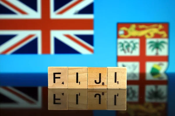 Fiji Flag and country name made of small wooden letters. Studio shot.