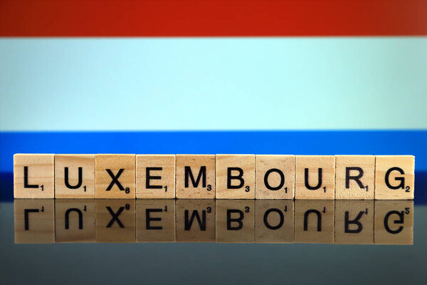 Luxembourg Flag and country name made of small wooden letters. Studio shot.