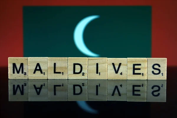 Maldives Flag and country name made of small wooden letters. Studio shot.
