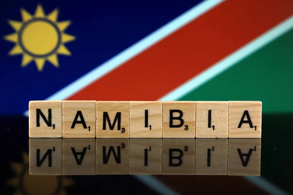 Namibia Flag and country name made of small wooden letters. Studio shot.