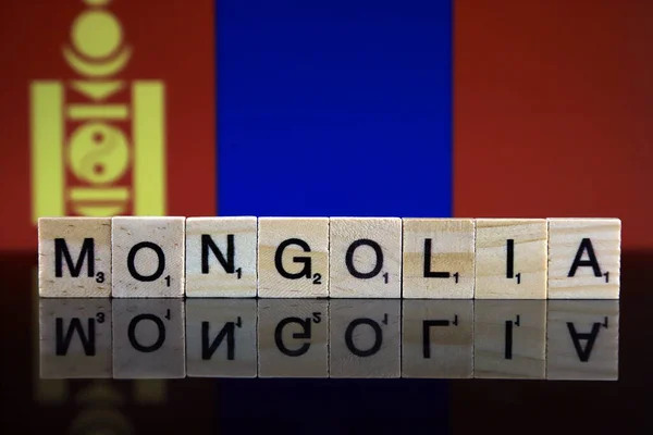 Mongolia Flag and country name made of small wooden letters. Studio shot.