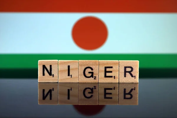 Niger Flag and country name made of small wooden letters. Studio shot.
