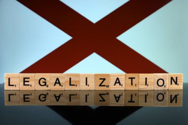 Wroclaw, Polonya - 4 Şubat 2020: Alabama Eyalet Bayrağı ve küçük tahta harflerden yapılmış kelime yasallaştırma. Uyuşturucu politikası. Esrarın yasallaştırılması.