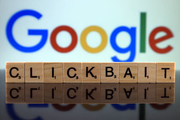 WROCLAW, POLAND - FEBRUARY 12, 2020: Word CLICKBAIT made of small wooden letters, and GOOGLE logo in the background. Studio shot.