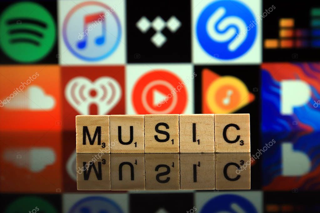 WROCLAW, POLAND - FEBRUARY 19, 2020: Word MUSIC made of wooden letters, and SPOTIFY, ITUNES, TIDAL, SHAZAM, DEEZER, SOUNDCLOUD, IHEART RADIO, YOUTUBE MUSIC, GOOGLE PLAY MUSIC, PANDORA logos.