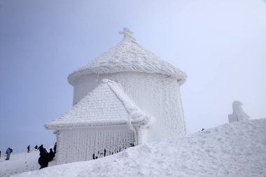 KARPACZ, POLAND - 08 Mart 2020: Kışın St. Lawrence Kilisesi. Sniezka Dağı 'nın zirvesinde (deniz seviyesinden 1602 metre yukarıda) bulunan Roma Katolik kilisesi, Dev Dağlar, Polonya, Avrupa.