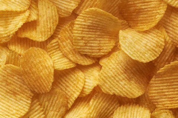 Hintergrund gewellte goldene Chips mit Textur — Stockfoto