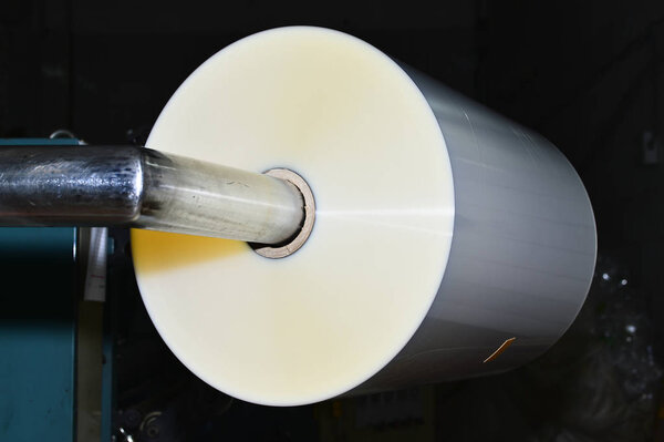 A roll of transparent film on the bar slitter-rewinders.