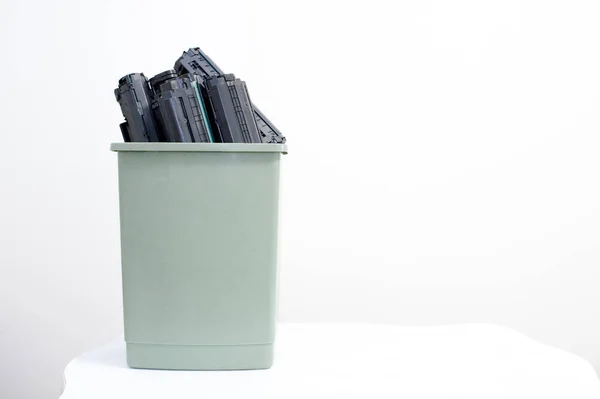 Spent cartridges are stacked in a container on a white background. — Stock Photo, Image