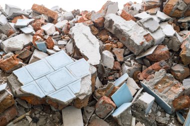 Yıkılmış duvarın kalıntıları taş, tuğla, kiremit şeklinde. Arkaplan