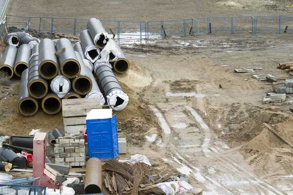 Construction site with a lot of pipes , fittings, concrete blocks. Background. The view from the top.