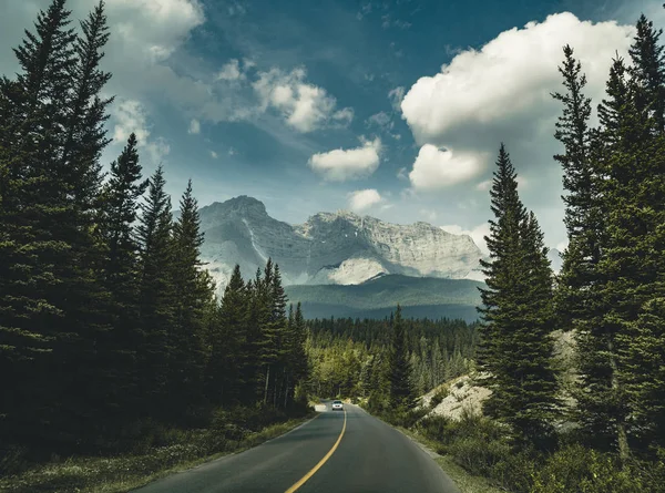 Empty street with mountain panorama in Banff National Park, Cana