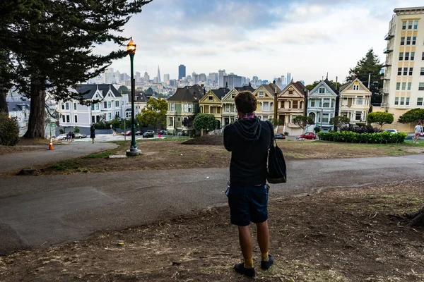 Young man looking towards Painted Ladies with street light in Sa — Stock Photo, Image