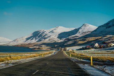 Empty Street with Icelandic Landscape during Sunrise Golden Hour clipart