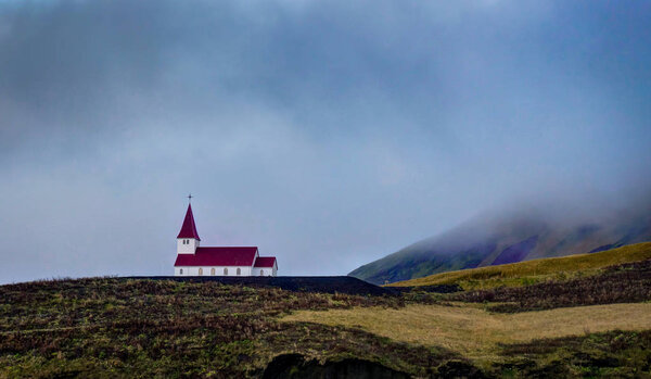 Church Iceland with red roof in nature meadows