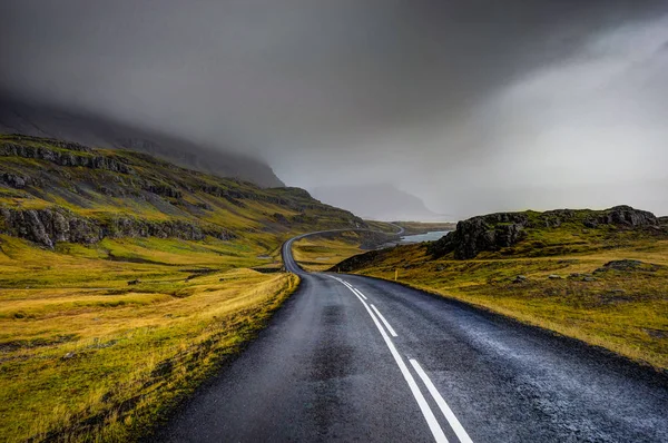 Calle vacía con paisaje islandés durante con montaña brumosa — Foto de Stock