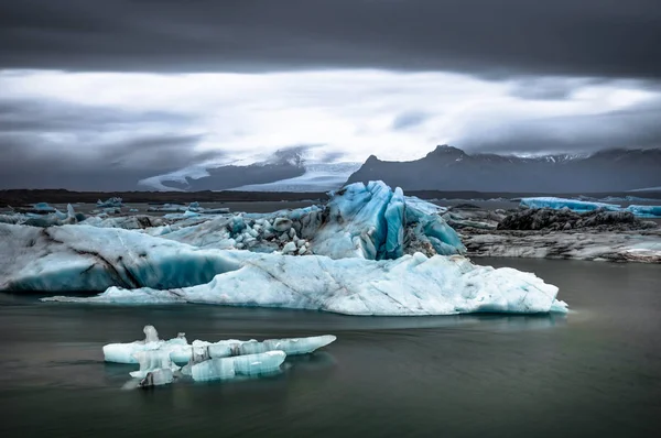 Icebergs flotando en el lago glaciar Jokulsarlon al atardecer en Icela —  Fotos de Stock