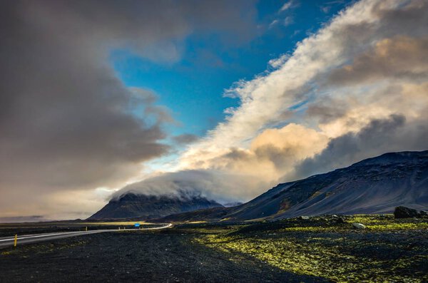 Vatnajokull Glacier covered in fog with mountains and blue sky