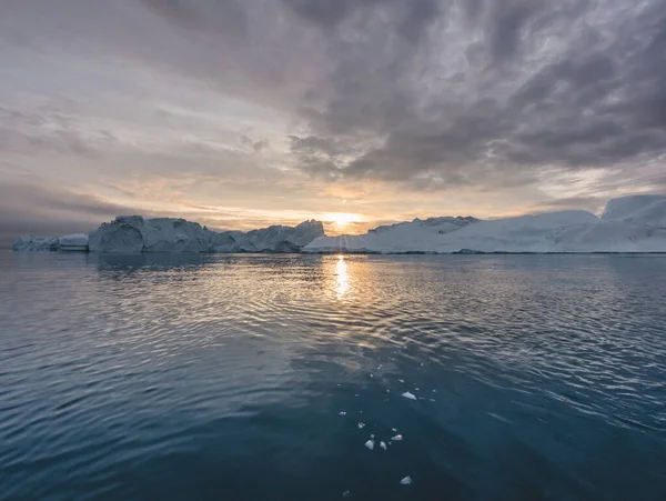 Арктичні природні ландшафти з айсбергами в Гренландії з опівнічним заходом сонця в горизонті. Ранковий літній альпенгейв увечері. Ілулісат (Західна Ґренландія). — стокове фото