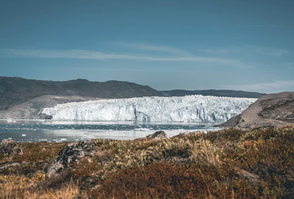 Grónský ledovec s mořským ledem a ledovou krajinou poblíž ledovce Eqip Sermia, Eqi v západním Grónsku u arktického města Ilulissat. Modrá obloha za slunečného dne. Telata Ledovec. — Stock fotografie