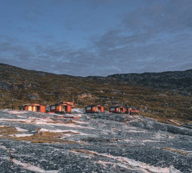 Panoramic image of Camp Eqi at Eqip Sermia Glacier in Greenland. nature landscape with lodge cabins. Midnight sun and pink sky. Tourist destination Eqi glacier in West Greenland AKA Ilulissat and clipart
