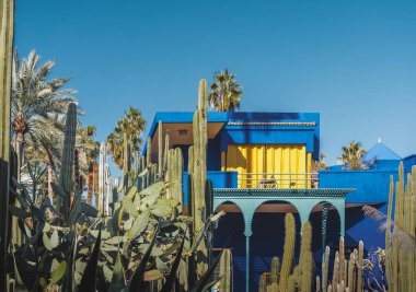 The beautiful Majorelle Garden is a botanical ,tropical garden and artists landscape garden in Marrakech, Morocco. Le Jardin has a water fountain painted in Majorelle Blue. clipart