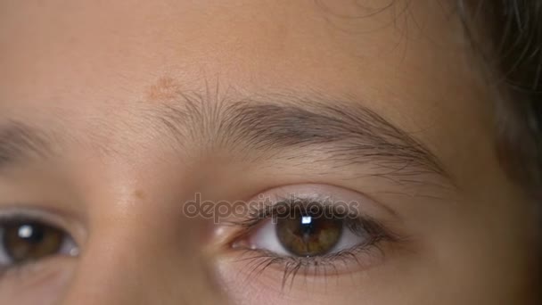 A boys brown eyes with long black eyelashes. 4k, slow motion, close-up — Stock Video
